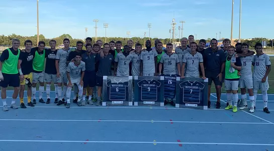 Men's soccer celebrated senior night before the game. Everyone gathered at the track for a picture.