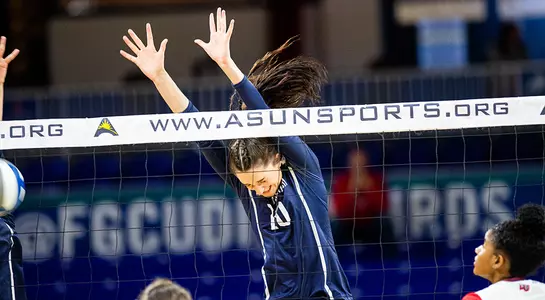 Maddie Boyd jumps up to block an attack.