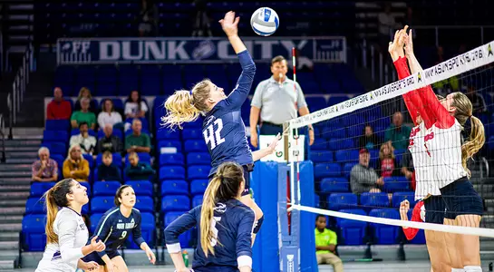 Taryn Griffey jumps up to spike the ball over the net.