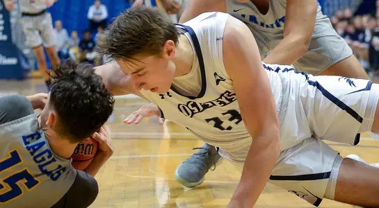 Carter Hendricksen battles for a ball on the floor against an opponent