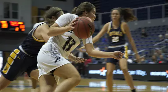 Rhetta Moore drive the lane against Warner.