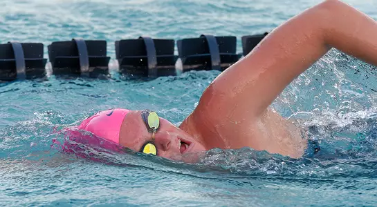Katie Couch swims a freestyle stroke in the water.