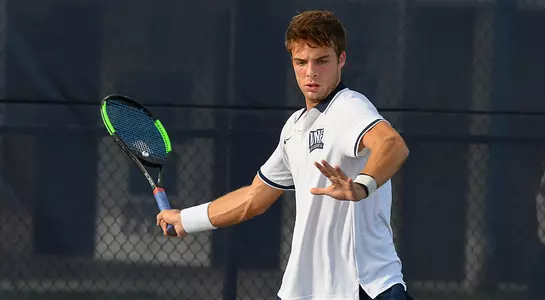 Nilo Duarte looks at the tennis ball before making contact with in it on a forehand.