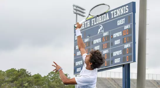 Action shot of Sahil Deshmukh delivering a serve.