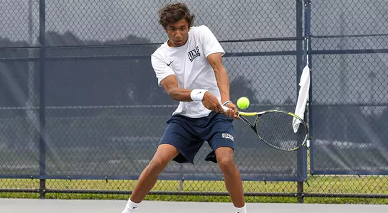 Sahil Deshmukh action shot of him hitting a two-handed backhand return.