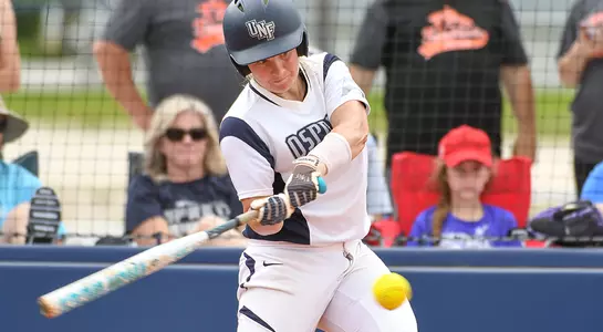 Action shot of softball player Tiffany Lower hitting an oncoming pitch.
