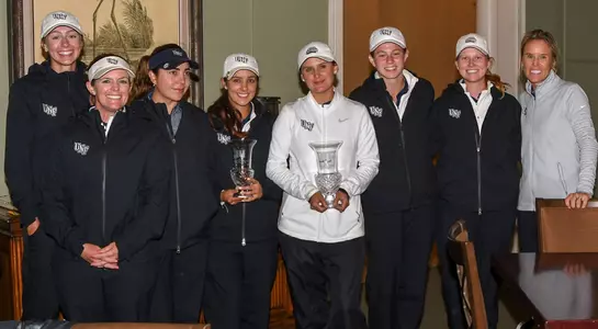 The North Florida women's golf team poses with the championship trophy after winning the title at the Amelia Island Collegiate
