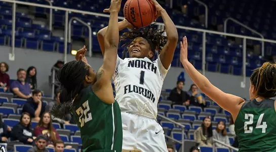 Arianna Wright takes a shot over a pair of defenders in the lane