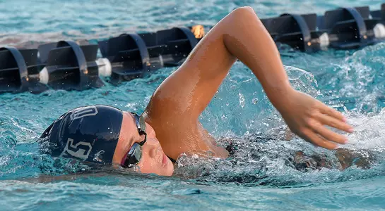 Lauren macaisa raises her right arm to complete a freestyle stroke.