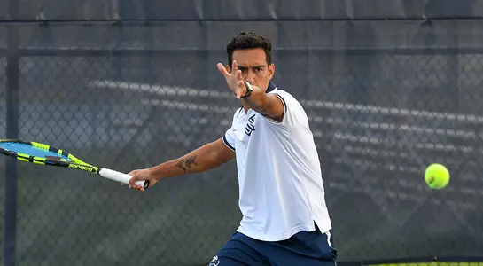 Federico Nani winds up for his forehand before hitting a tennis ball