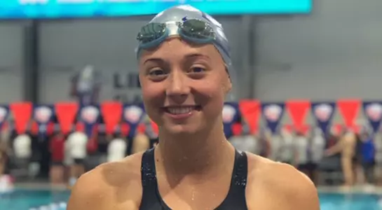 Camryn Greenleaf poses on the pool deck after setting school record in the 50-yard freestyle