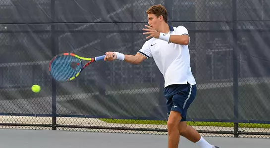Dominik Barton eyes the tennis ball as he prepares to hit a forehand.