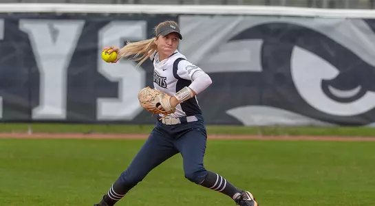 Action shot of Veronika Klimpova making a play and a throw at second base.