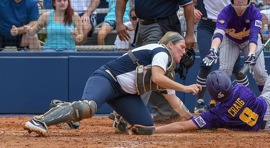 Action shot of Paige Pfent tagging a runner at home plate.