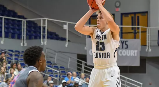Carter Hendricksen shoots a jump shot over a defenders outstretched hand
