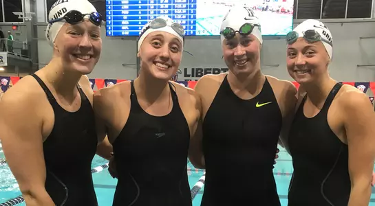 Osprey 400 Free Relay squad poses poolside