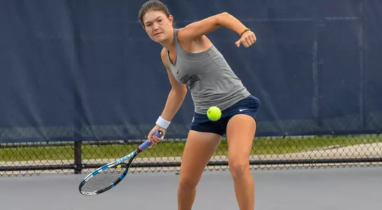 Action shot of Constanza Gorches hitting a forehand.