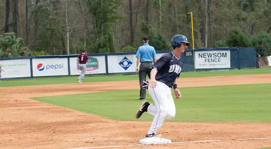 Tanner Clark runs and advances toward home