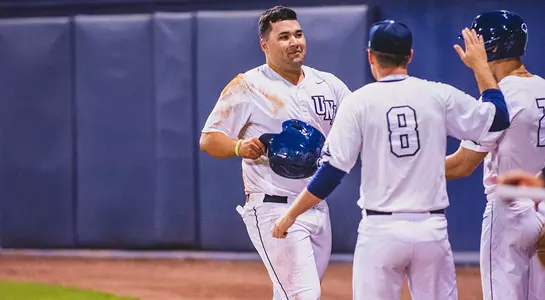 David Maberry, Brandon Reitz and Wes Weeks high five after Maberry came home to score on a sacrifice fly.