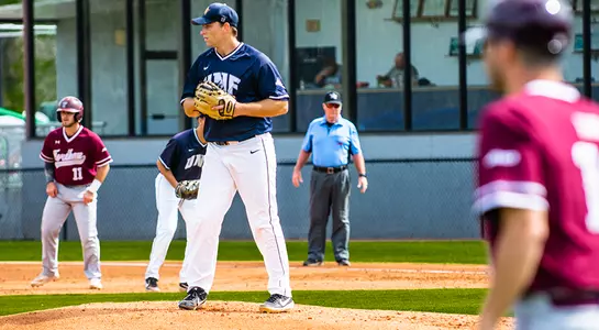 Max McKinley looks for runner stealing base before pitch is thrown