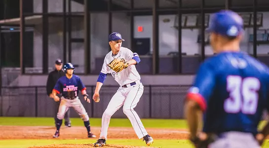 Logan Clayton reaches back before a pitch.
