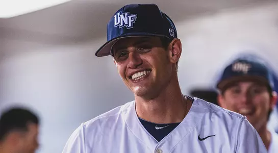 Nick marchese smiles in the dugout.