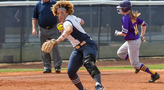 UNF softball player winds up for a pass