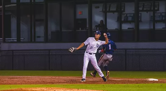 Alex Reynolds throws warm up grounders.