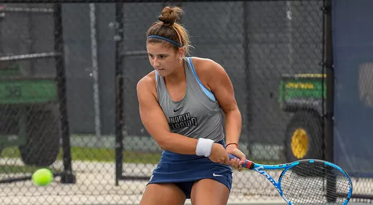 Action shot of Florencia Rossi hitting a two-handed backhand.
