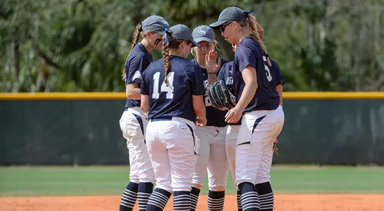 Team huddle in the middle of the infield of the 2018 UNF softball team.