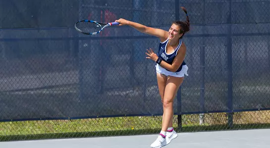 Action shot of Valentina Mariotto finishing her serve.