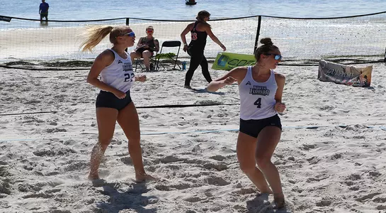 Carolyn Cain and Blaire Register play beach volleyball