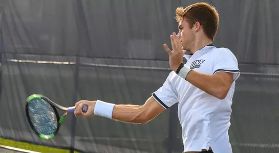 action shot of Nilo Duarte hitting a forehand.