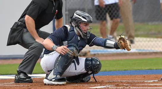 Action shot of Austin Hurwitz framing a pitch while he is catching behind home plate.