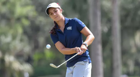 Mindy Herrick follows through on a chip shot from just off the green