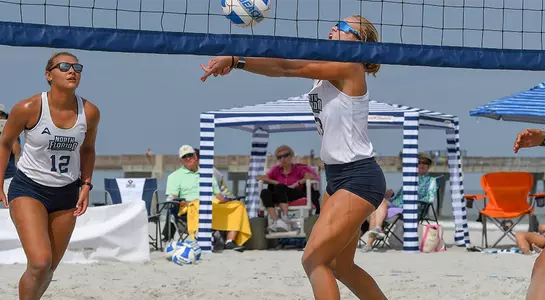 Jessi Freeman sets up teammate for a spike at UNF Invitational