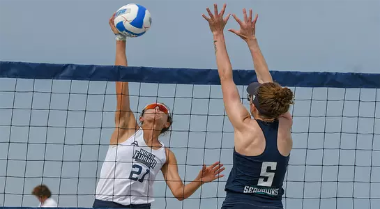 Antonia Harrison spikes ball over net at UNF Invitational