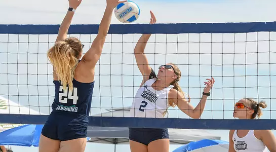 Callie Workman challenges opponent at net to win ball