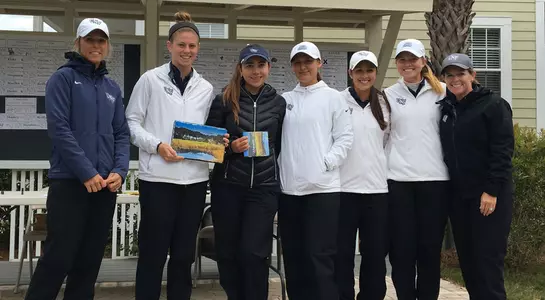 North Florida women's golf team poses with team trophy after winning the Edisto Island Invitational