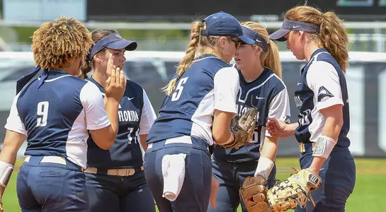 North Florida softball huddles on the infield.