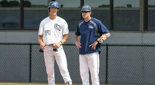 Tanner Murphy stands at first base with assistant coach Andrew Hannon