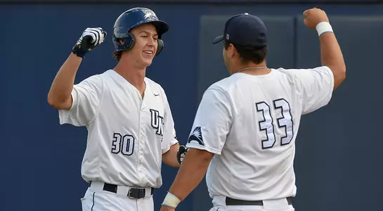 Baseball players Blake Marabell and David Maberry celebrate at home plate.
