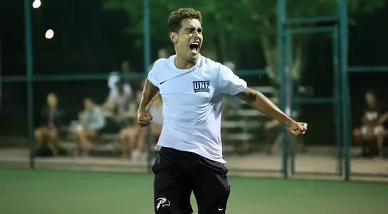 Federico Nani celebrates the match-winning point on the tennis courts.