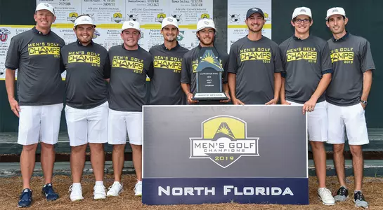 The North Florida men's golf team poses with ASUN Championship trophy after winning the title