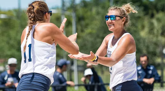 Nicole DeBolt and Madilyn McCarty give each other high fives during a match.