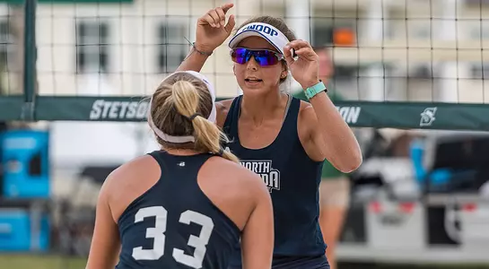 Chaney Howard and Brittany Pase high five each other.