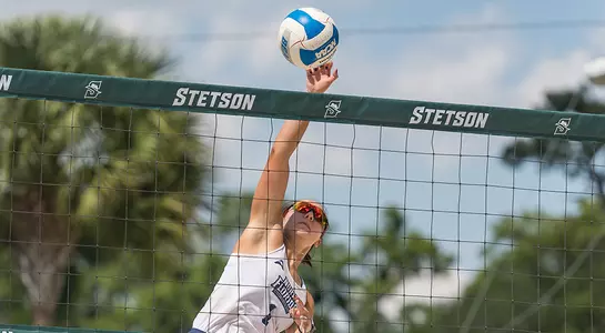Dana Roskic makes contact with the ball near the net.