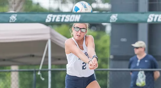 Callie Workman gets under the ball to dig it out.