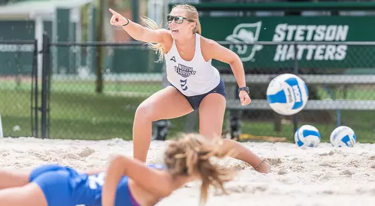 Callie Workman points at her partner after winning a point.