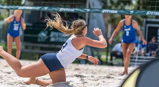 Callie Workman dives after the ball to dig it out.